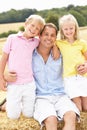 Father And Children Sitting On Straw Bales In Harv Royalty Free Stock Photo