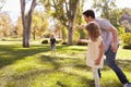 Father With Children Throwing Frisbee In Park Together