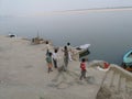 Father and children untangle fishing net near Assi Ghat Varanasi India