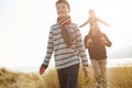 Father And Children Walking Through Dunes On Winter Beach Royalty Free Stock Photo