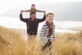 Father And Children Walking Through Dunes On Winter Beach Royalty Free Stock Photo