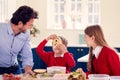 Father With Children Wearing School Uniform Having Fun Making Healthy Sandwich For Lunch At Home Royalty Free Stock Photo