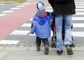 Father with children on zebra crossing