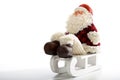 Father Christmas sitting on sledge on white