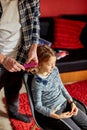 Father combing, brushing his daughter& x27;s hair at home Royalty Free Stock Photo