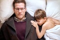 Father come to say goodbye to child boy before leave for work in morning, on bed