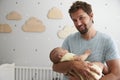 Father Comforting Newborn Baby Son In Nursery Royalty Free Stock Photo