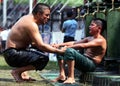 A father comforts his son after he lost his bout at the Kirkpinar Turkish Oil Wrestling Festival at Edirne in Turkey. Royalty Free Stock Photo