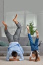 father copy imitate active child girl doing gymnastic handstand exercise
