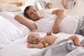 Father with his cute baby sleeping in bed at home Royalty Free Stock Photo