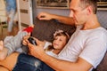 Father and cute little daughter using digital devices at home. Royalty Free Stock Photo