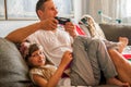 Father and cute little daughter using digital devices at home. Royalty Free Stock Photo