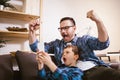 Father and cute little son using phone apps together, watching cartoons or video, playing game Royalty Free Stock Photo