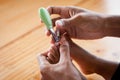 Father cutting toenails for her baby