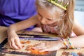 Father and daughter assemble the puzzle while sitting at the table. Games during rain and bad weather, quarantine. Family relaxing Royalty Free Stock Photo