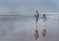 Father Daughter on Beach Low Tide Reflection in Fog Royalty Free Stock Photo