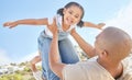 Father and daughter bonding together outdoors. Portrait of adorable little girl from below having fun pretending to fly Royalty Free Stock Photo