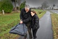 Father and daughter with broken umbrella