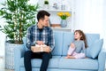 Father and daughter or brother and sister with a gift in the interior of the room. Father`s day holiday concept, Children`s Day Royalty Free Stock Photo