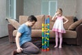 Father and daughter build ball slide tower