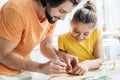 father and daughter carving cucumber while cooking