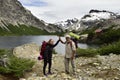 Father and daughter celebrate on the shore of a lake having finished a walk Royalty Free Stock Photo