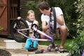 Father And Daughter Cleaning Bike Together