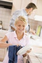 Father And Daughter Cleaning Dishes