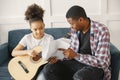 African father teaches his daughter to play guitar Royalty Free Stock Photo