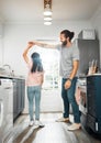 Father and daughter dancing together, having family fun in the kitchen at home. Carefree, happy and loving parent Royalty Free Stock Photo