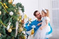Father and daughter decorate a Christmas tree. Royalty Free Stock Photo