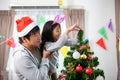 Father and daughter is decorating Christmas tree and enjoying Christmas time Royalty Free Stock Photo