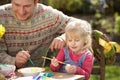 Father And Daughter Decorating Easter Eggs