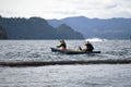 Father with daughter and dog rowing in boat on the troubled lake Merwin Royalty Free Stock Photo