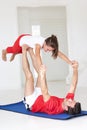 Father and daughter doing yoga lift