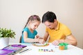 Father and daughter draw a rainbow together. Father and child spend a fun time while drawing. Happy family Royalty Free Stock Photo