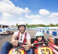 Father and daughter driving go kart on the track Royalty Free Stock Photo