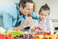 father with daughter eating pepper together Royalty Free Stock Photo