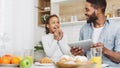 Father and daughter eating sweets and looking for new recipes