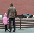 Father and daughter at the Eternal Flame Memorial at the Kremlin walls in Moscow