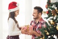 Father and daughter exchanging and opening Christmas presents Royalty Free Stock Photo