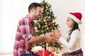 Father and daughter exchanging and opening Christmas presents Royalty Free Stock Photo