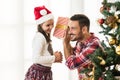 Father and daughter exchanging and opening Christmas presents Royalty Free Stock Photo