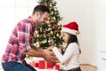 Father and daughter exchanging and opening Christmas presents Royalty Free Stock Photo