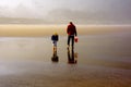 Man and Child Explore Beach Low Tide Royalty Free Stock Photo