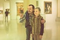 Father and daughter exploring expositions in museum