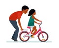 Father and daughter. Father helping daughter to ride a bike. White background. African American people. Royalty Free Stock Photo