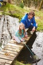 Father And Daughter Fishing In Pond With Net Royalty Free Stock Photo