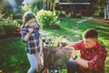 Father and daughter fixing problems with bicycle outdoor in summer. Royalty Free Stock Photo
