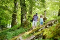 Father and daughter following a footpath around La Verna Sanctuary, Chiusi della Verna, in Casentino secular forest, one of the